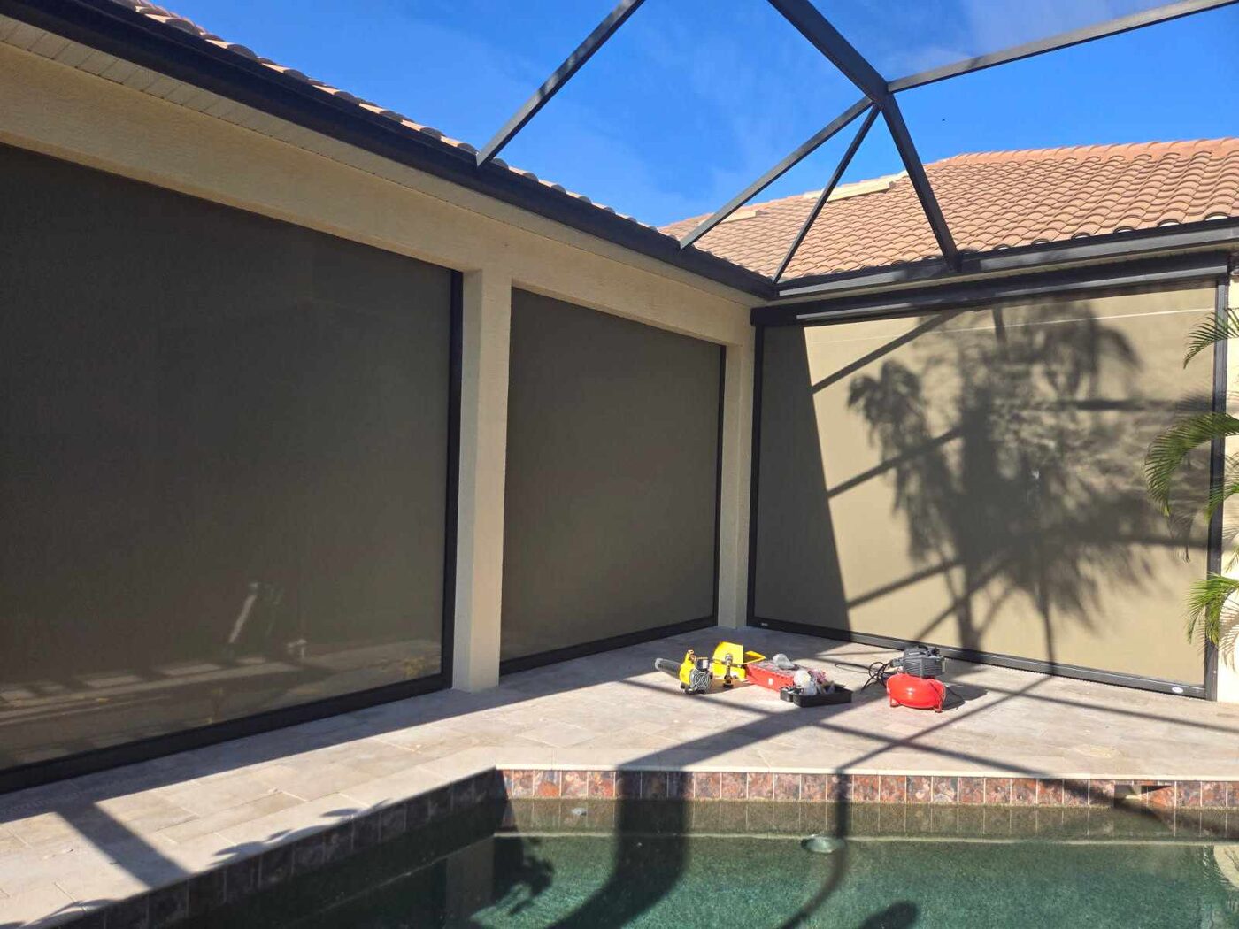 Corner motorized screen installation under pool cage