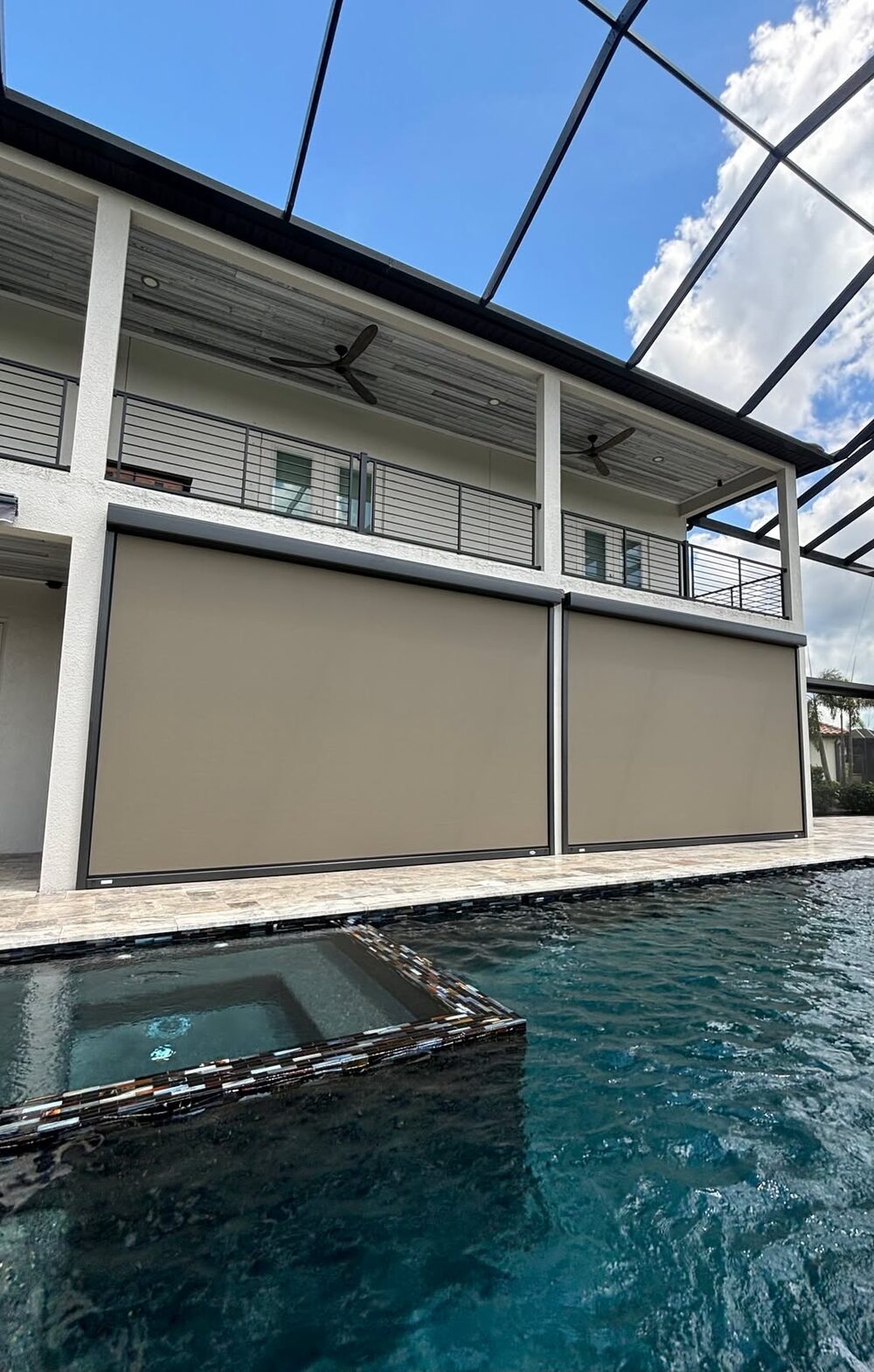 Two-story motorized outdoor screens installed on a Nokomis pool home